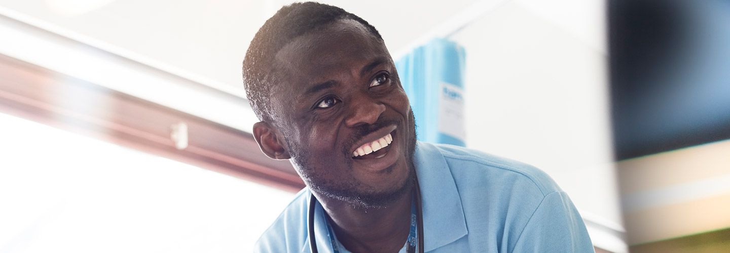 Male student smiling with a stethoscope